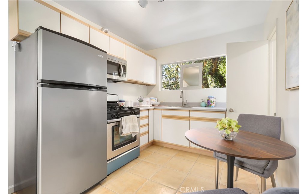 1237 Olive Lane La Canada Flintridge, CA 91011 - Photo 43 of 57 a kitchen with stainless steel appliances a refrigerator a stove a sink and a dining table