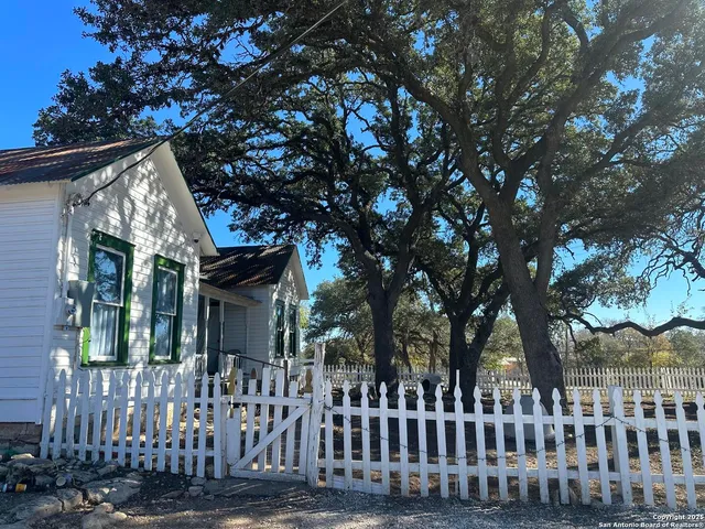 a view of a house with a tree