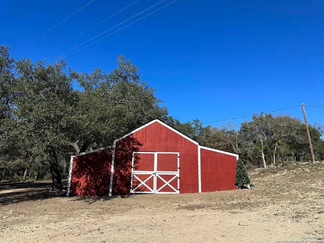 a view of wooden fence under a large tree