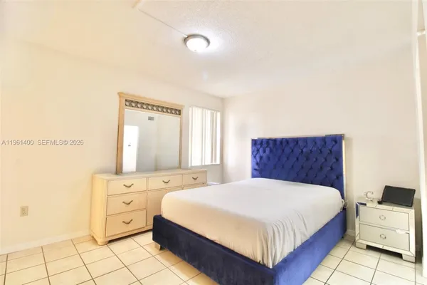 a bedroom with a bed and a night stand