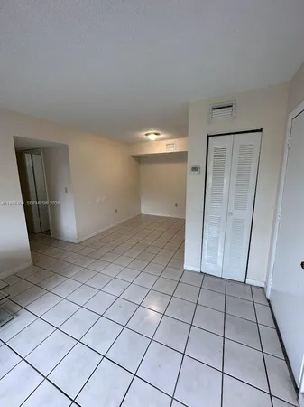 a view of an empty room and entryway