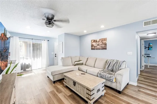 a living room with furniture and a kitchen view