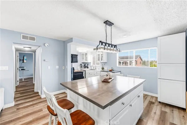 a kitchen with stainless steel appliances granite countertop a sink stove and cabinets