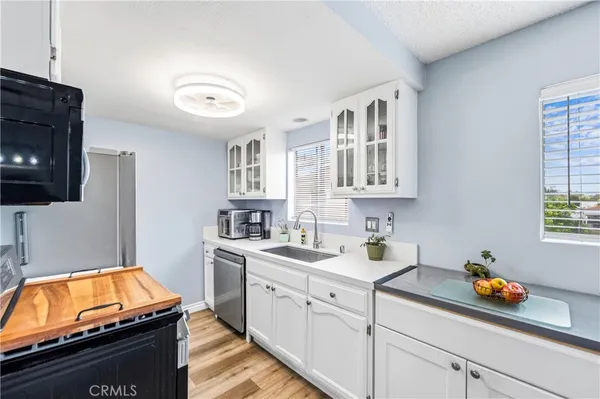a kitchen with stainless steel appliances granite countertop a stove a refrigerator and a microwave