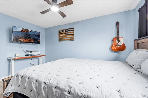 a bedroom with a bed and a television