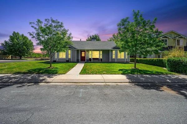 a front view of a house with a yard and a garage