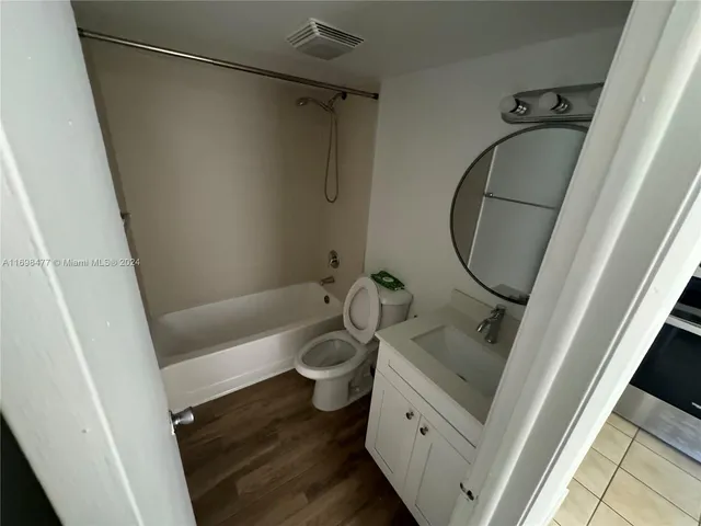 a bathroom with a sink a mirror and a toilet