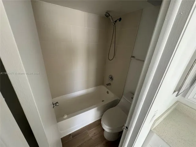a bathroom with a tub and toilet