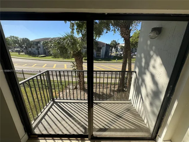 a view of a balcony with wooden floor