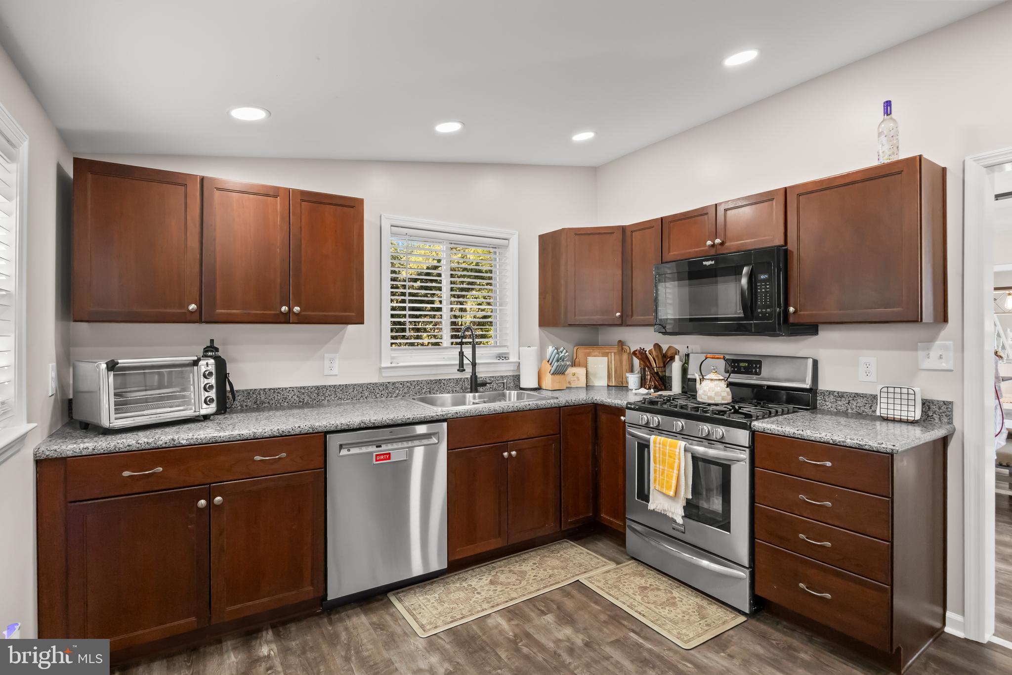 2191 Garwood Road Sicklerville, NJ 08081 - Photo 13 of 36 a kitchen with stainless steel appliances granite countertop wooden cabinets a stove a sink and a microwave