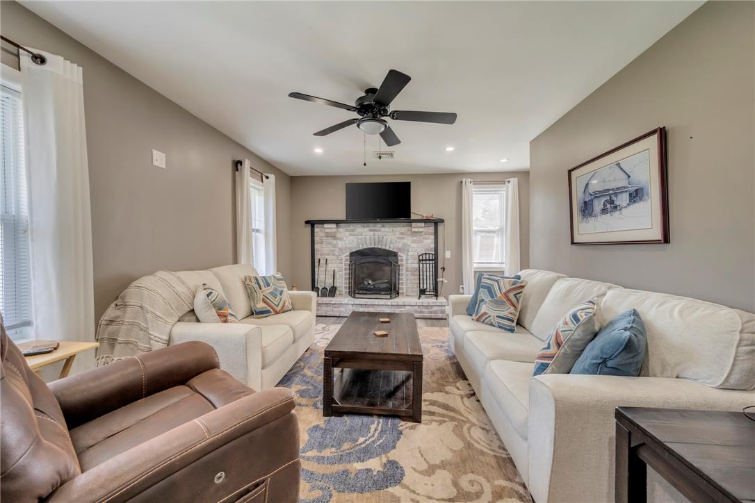 439 Cherry Hill Road Nazareth, PA 18064 - Photo 11 of 31 A comforting living area with a stone fireplace anchors the room, offering warmth and a focal point.