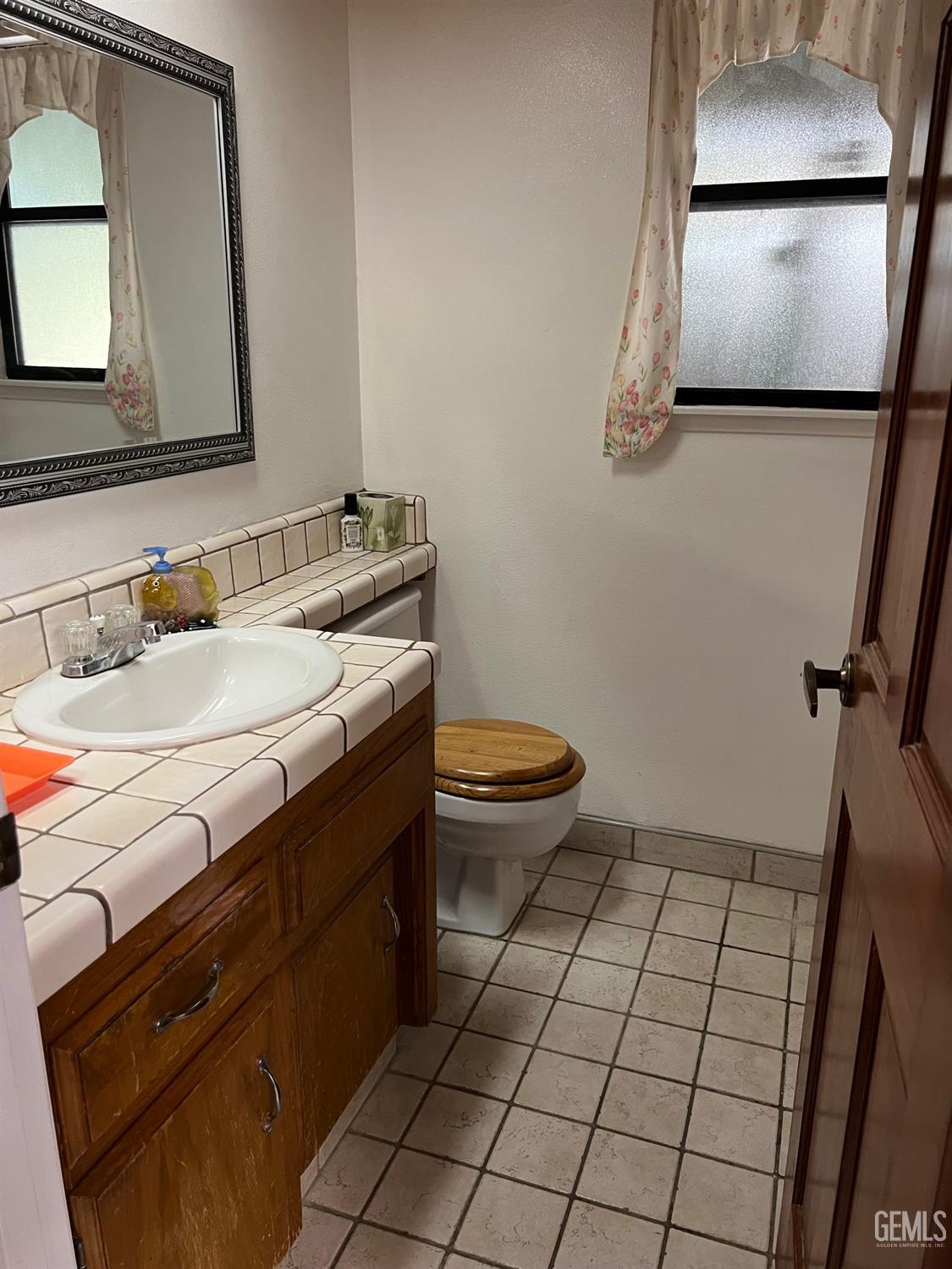 Undisclosed Address Bakersfield, CA 93311 - Photo 12 of 14 a bathroom with a sink a toilet and mirror