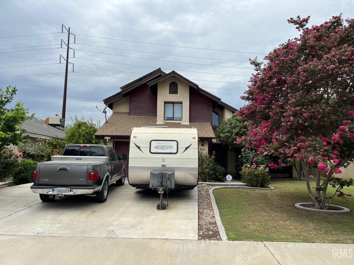 Undisclosed Address Bakersfield, CA 93311 - Photo 2 of 14 a car parked in front of white house