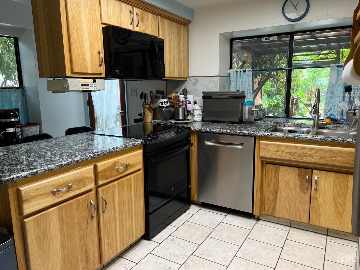 Undisclosed Address Bakersfield, CA 93311 - Photo 7 of 14 a kitchen with stainless steel appliances granite countertop a stove sink and cabinets