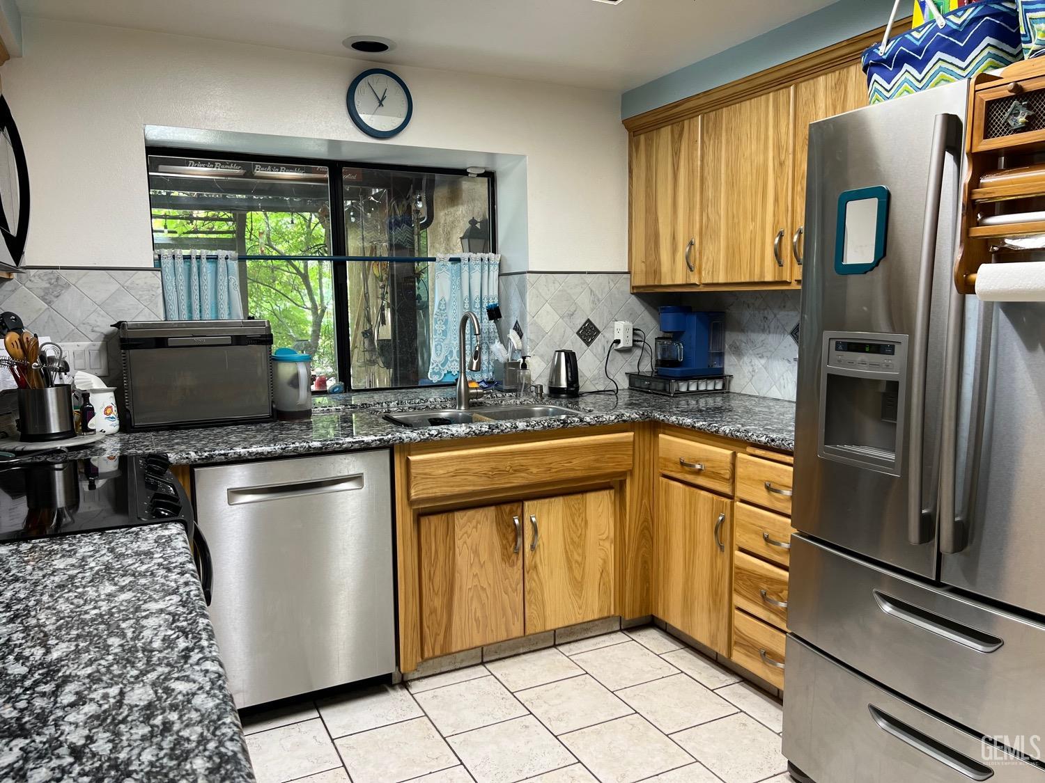 Undisclosed Address Bakersfield, CA 93311 - Photo 8 of 14 a kitchen with stainless steel appliances a stove a sink and a refrigerator