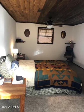 a bedroom with bed and a table