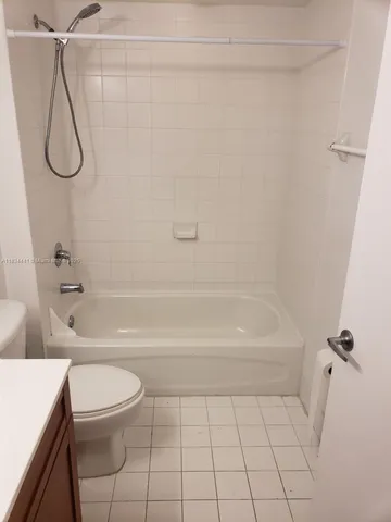 a bathroom with a bathtub a toilet and a shower