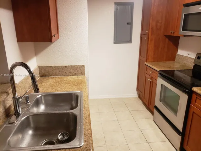 a close view of a sink and a stove in a kitchen