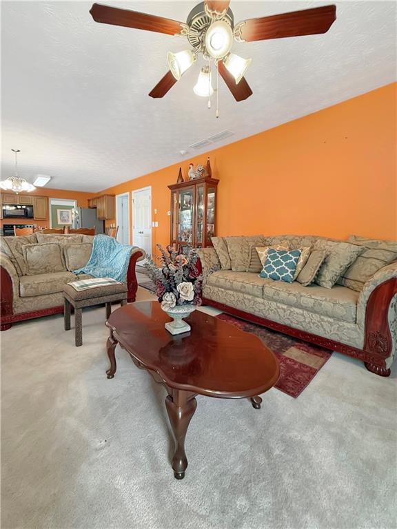235 Shiver Boulevard Covington, GA 30016 - Photo 13 of 27 a living room with furniture and a chandelier