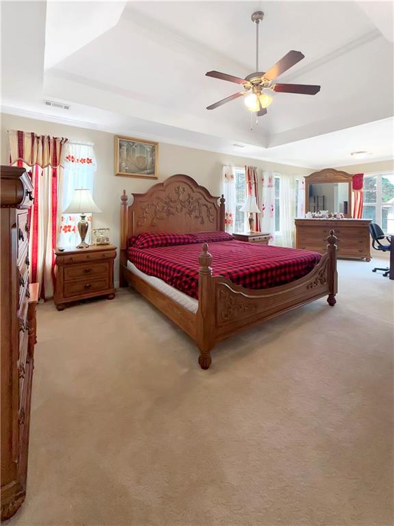 235 Shiver Boulevard Covington, GA 30016 - Photo 14 of 27 a spacious bedroom with a bed and a chandelier