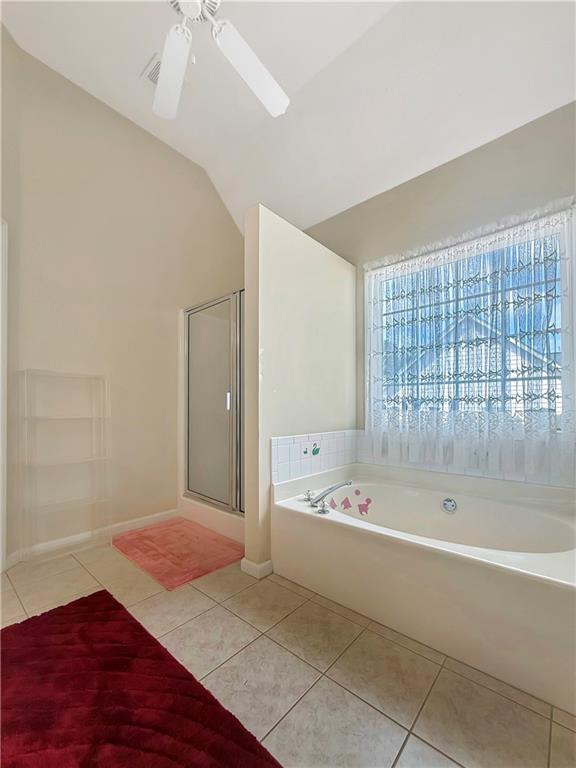 235 Shiver Boulevard Covington, GA 30016 - Photo 18 of 27 a bathroom with a bathtub and a shower