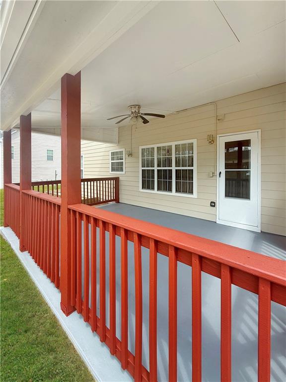 235 Shiver Boulevard Covington, GA 30016 - Photo 19 of 27 a view of a porch with wooden floor and fence