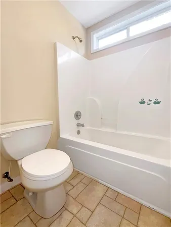 a bathroom with a toilet and a bathtub