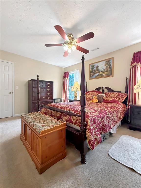 235 Shiver Boulevard Covington, GA 30016 - Photo 24 of 27 a bedroom with a bed and ceiling fan