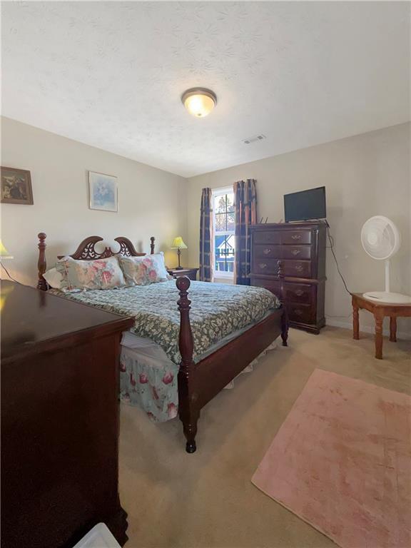 235 Shiver Boulevard Covington, GA 30016 - Photo 25 of 27 a bedroom with a bed and dresser