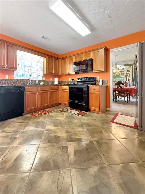 235 Shiver Boulevard Covington, GA 30016 - Photo 9 of 27 a large kitchen with stainless steel appliances granite countertop a stove a sink and a refrigerator
