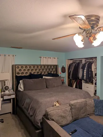 a bedroom with a bed and a chandelier