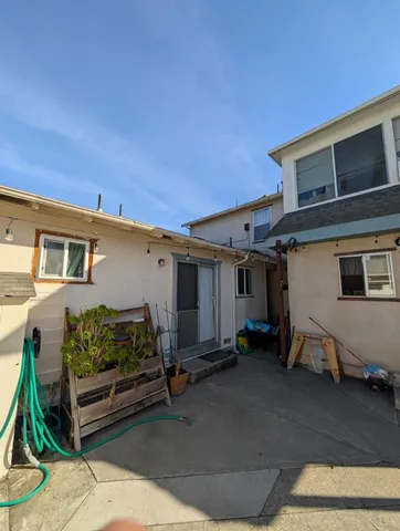 a view of a house with a backyard and a car