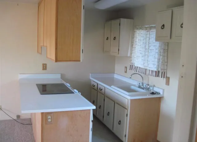a kitchen that has a sink and a stove in it