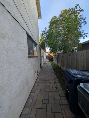 a backyard of a house with table and chairs
