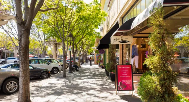 a street view with tall buildings and cars