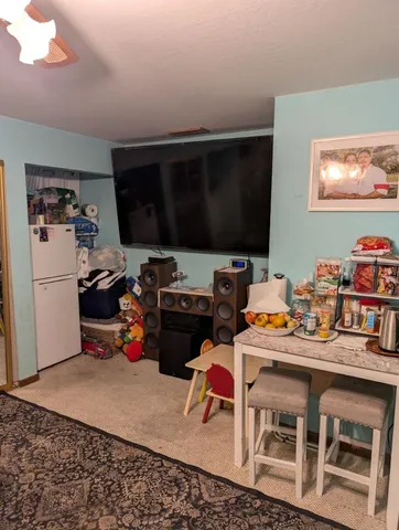 a room with furniture a flat screen tv and a window