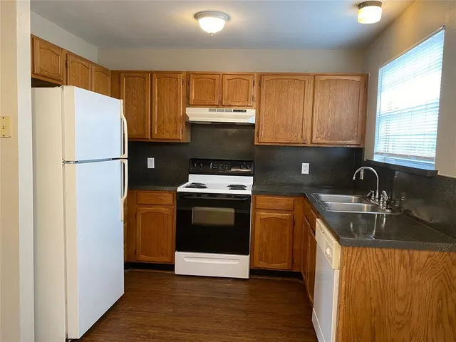 a kitchen with a refrigerator sink and stove