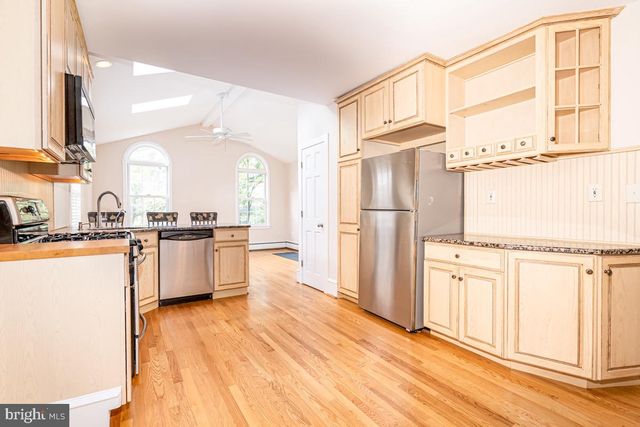 a kitchen with stainless steel appliances a refrigerator and a stove top oven