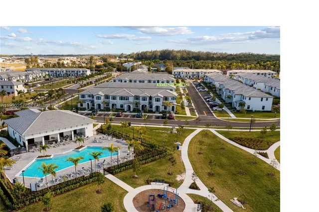 a view of a swimming pool with lawn chairs