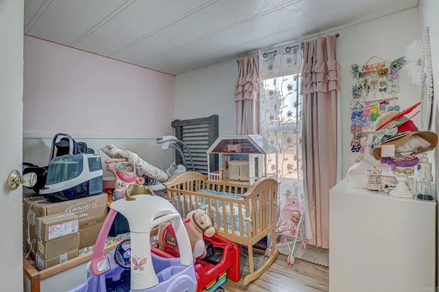 a bedroom with furniture and a baby crib