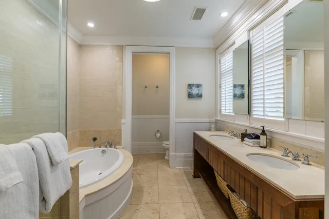 a bathroom with a double vanity sink double mirror and a bathtub