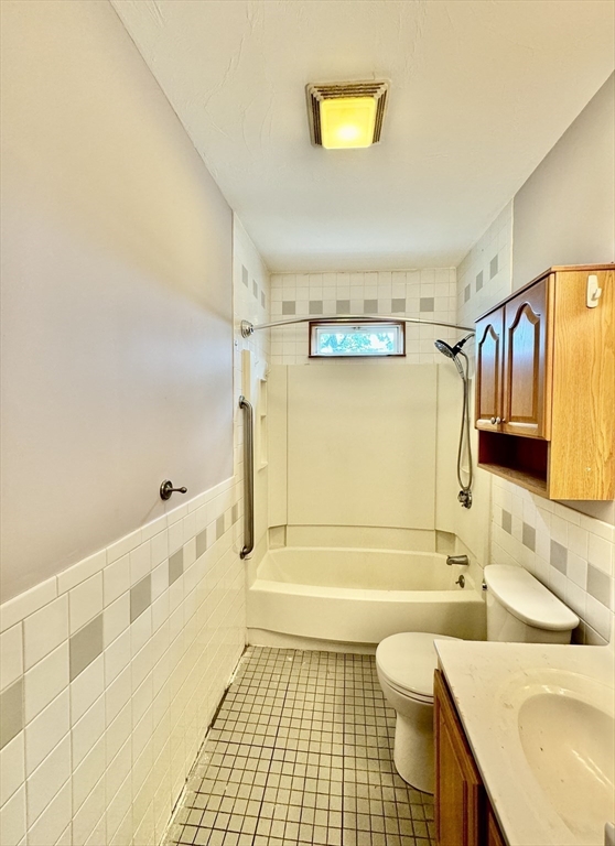 7 Rawson Road, Unit 1 Quincy, MA 02170 - Photo 3 of 17 a bathroom with a sink a toilet and shower