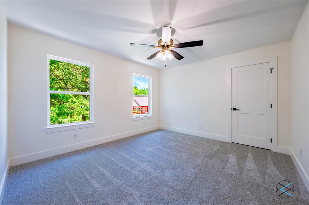 114 Castlewood Road Enchanted Oaks, TX 75156 - Photo 14 of 24 an empty room with windows and fan