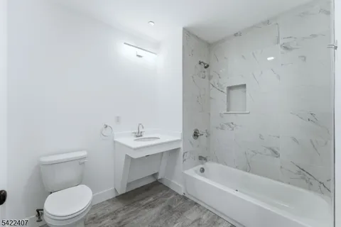 a bathroom with a toilet a sink and bathtub