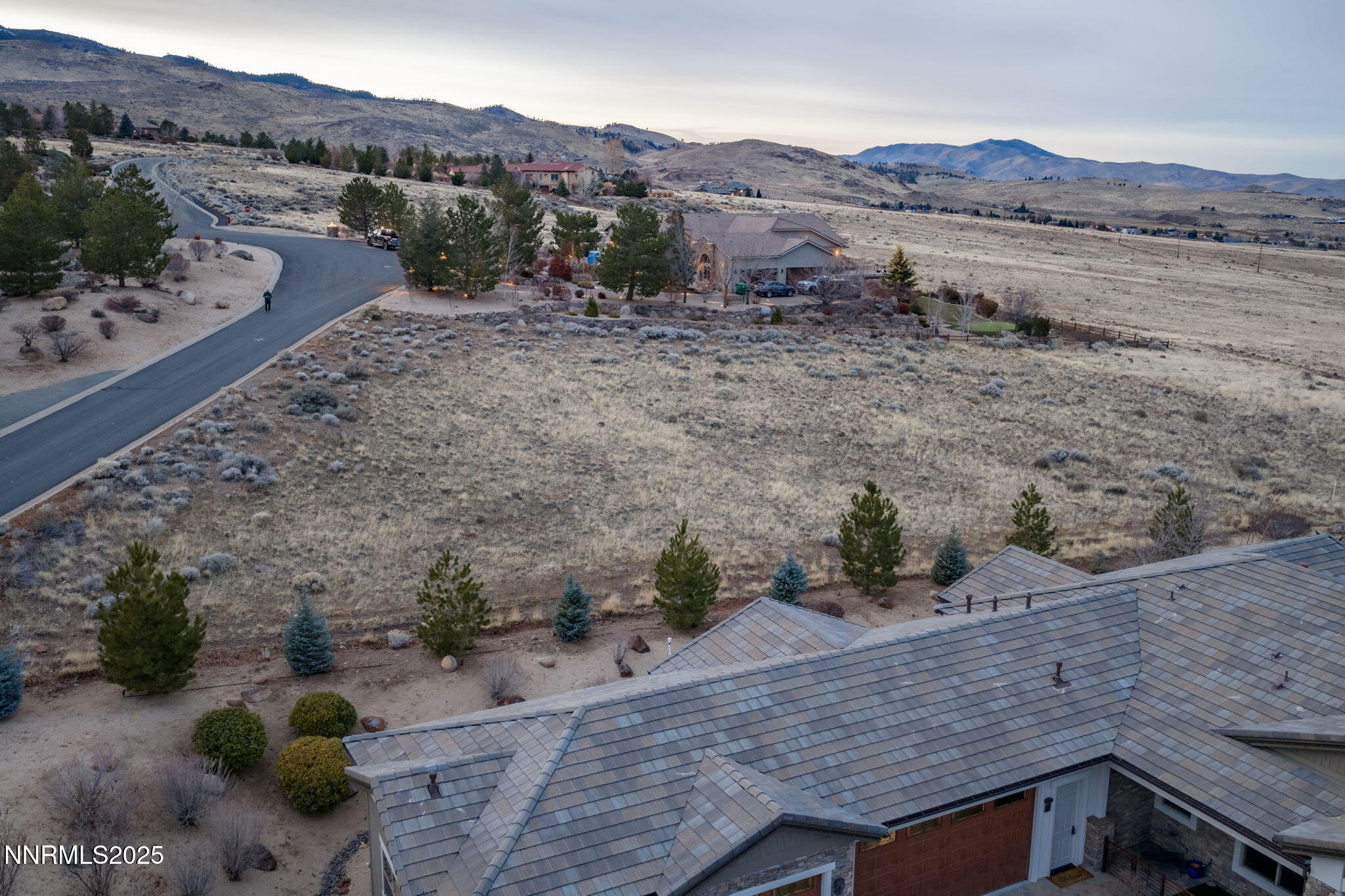 390 Questa Court Reno, NV 89511 - Photo 19 of 29 a view of a dry dry field with mountains in the background