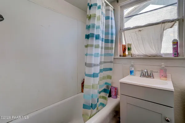 a bathroom with a sink toilet vanity and tub