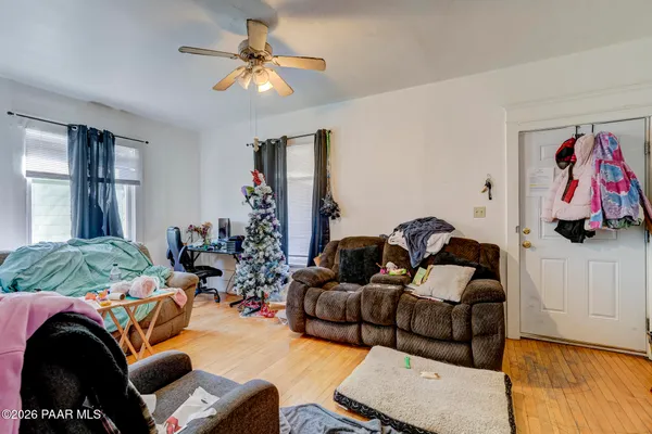 a living room with furniture ceiling fan and a rug