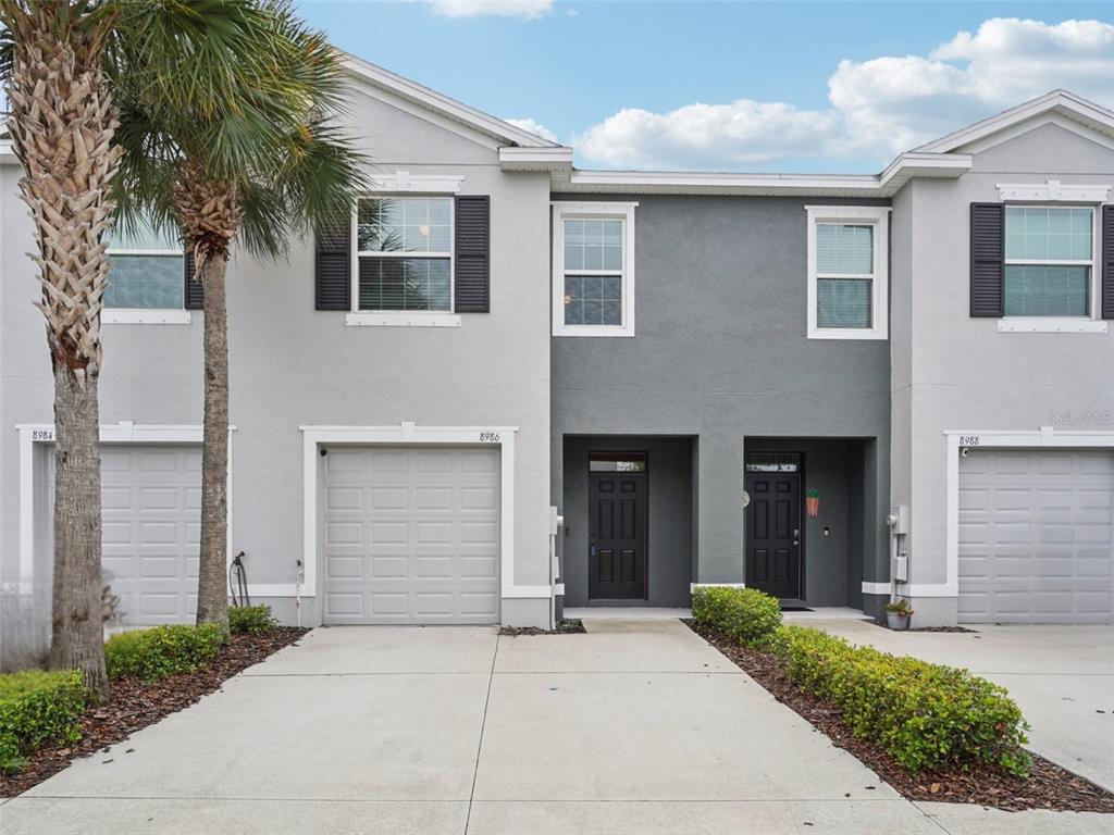 8986 Indigo Trail Loop Riverview, FL 33578 - Photo 1 of 48 a front view of a house with yard and parking