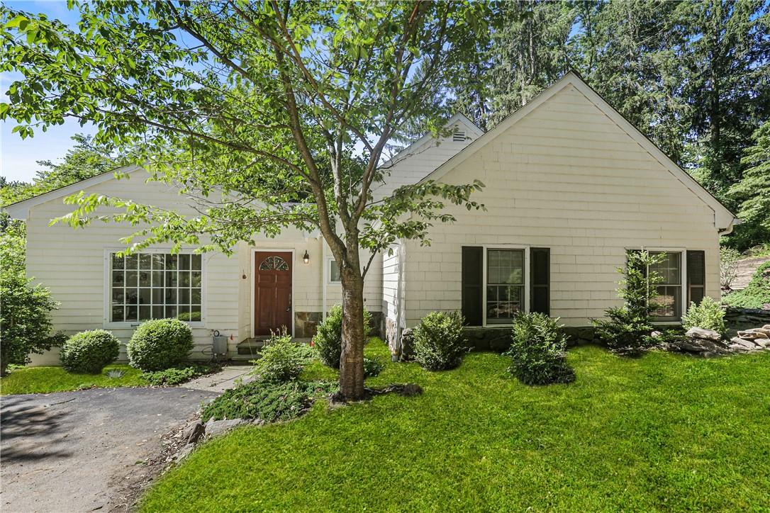 248 Quaker Road Chappaqua, NY 10514 - Photo 1 of 1 a view of a house with garden and plants