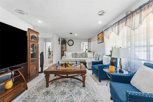 a living room with furniture a rug and a flat screen tv
